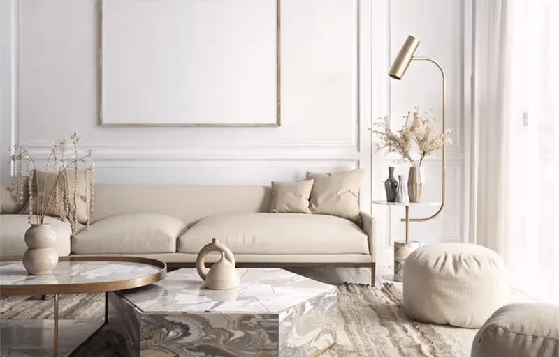 Sala de estar minimalista com sofá bege, mesa de centro marmorizada, tapete texturizado e lâmpada de chão dourada.